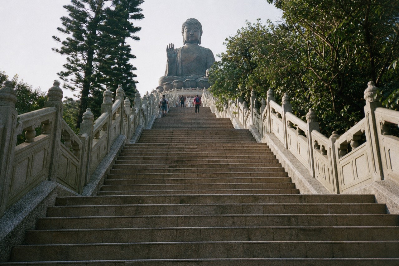 The stone stairway rising toward the seated Tian Tan Buddha above Ngong Ping, no text, no logos, no people