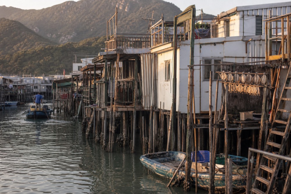 Stilt houses standing over the water along the Tai O waterfront, no text, no logos, no people