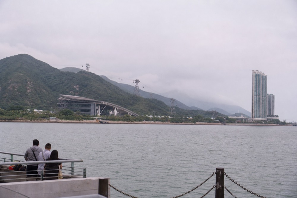Lantau Island coastline with green hills rising above the sea, no text, no logos, no people