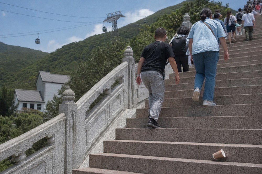 Crowds climbing the 268 steps to the Tian Tan Buddha, no text, no logos, no people