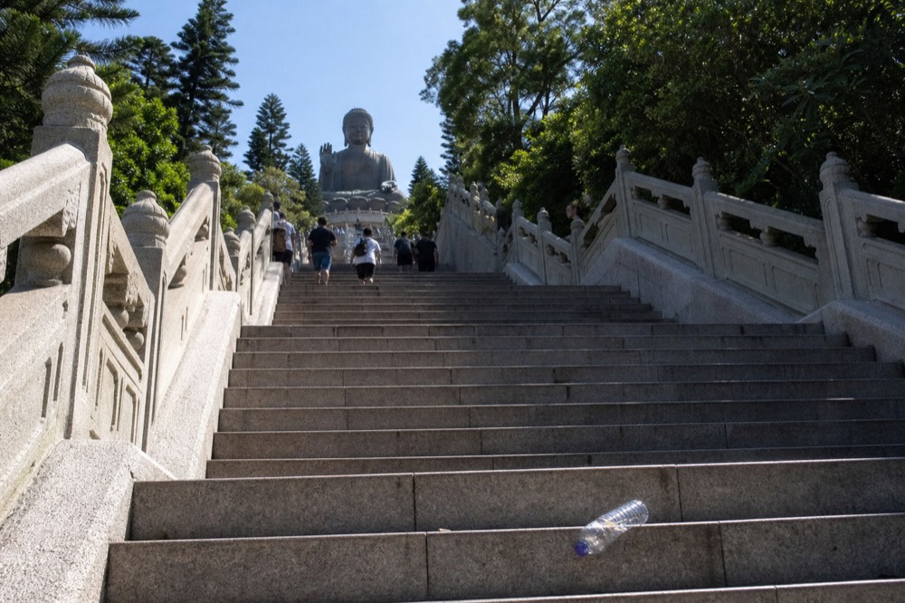 Stone steps rising toward the Tian Tan Buddha statue, no text, no logos, no people