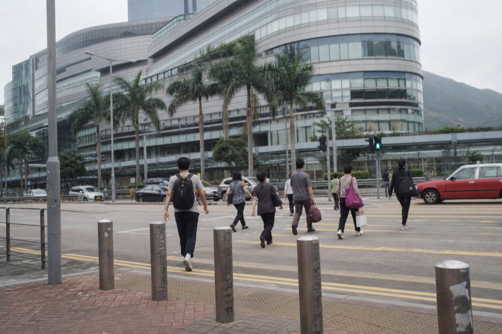 Citygate Outlets shopping mall exterior in Tung Chung, with shoppers and palm trees, no text, no logos, no people